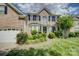 Beautiful brick home with manicured lawn and walkway leading to the front door at 12125 Mountainside Ln, Charlotte, NC 28278