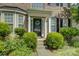 Inviting front entrance with decorative wreath, covered porch, and manicured bushes at 12125 Mountainside Ln, Charlotte, NC 28278