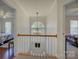 Upstairs hallway with hardwood railing and lighting at 12125 Mountainside Ln, Charlotte, NC 28278