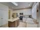 Open kitchen with stainless steel appliances, granite countertops, and a center island at 12125 Mountainside Ln, Charlotte, NC 28278