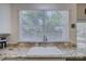 Close up of the kitchen sink, granite countertops, and a large window with natural light at 12125 Mountainside Ln, Charlotte, NC 28278