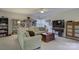 Inviting living room with a large sectional sofa, built-in bookshelves, and a ceiling fan at 12125 Mountainside Ln, Charlotte, NC 28278