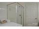 Modern shower with a glass door, white tiles, and ample space for a refreshing bathing experience at 12125 Mountainside Ln, Charlotte, NC 28278