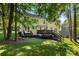Spacious backyard with a wooden deck, stairs, and mature trees, perfect for entertaining at 12602 Angel Oak Dr, Huntersville, NC 28078