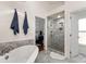 Stylishly designed bathroom featuring stand up shower, soaking tub and neutral paint palette at 12602 Angel Oak Dr, Huntersville, NC 28078