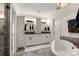 Bright bathroom features double vanity, granite countertop, soaking tub and updated fixtures at 12602 Angel Oak Dr, Huntersville, NC 28078