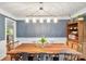 Bright dining room with a long table, modern chandelier, and a view of the doorway at 12602 Angel Oak Dr, Huntersville, NC 28078