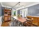 Dining room with a wooden table, blue accent wall, and a view into the foyer at 12602 Angel Oak Dr, Huntersville, NC 28078