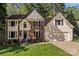 A beautiful home has brick and siding, complemented by a well-kept lawn and two-car garage at 12602 Angel Oak Dr, Huntersville, NC 28078