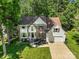 Charming brick and siding home featuring a manicured lawn and a two-car attached garage at 12602 Angel Oak Dr, Huntersville, NC 28078