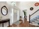 Inviting foyer with hardwood floors, staircase, and a view into the adjacent living spaces at 12602 Angel Oak Dr, Huntersville, NC 28078