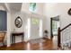 Bright foyer features hardwood floors, a high ceiling, and a white front door with transom window at 12602 Angel Oak Dr, Huntersville, NC 28078