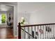 Bright hallway and landing featuring hardwood floors, chandelier and stylish accents at 12602 Angel Oak Dr, Huntersville, NC 28078