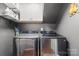 Convenient laundry room includes modern washer and dryer with storage at 12602 Angel Oak Dr, Huntersville, NC 28078