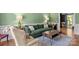 Cozy living room with a green sofa, modern coffee table, and a light-colored rug at 12602 Angel Oak Dr, Huntersville, NC 28078
