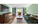 Inviting living room featuring green walls, wood floors, and comfortable seating at 12602 Angel Oak Dr, Huntersville, NC 28078
