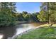 A scenic pond surrounded by lush greenery, offering a peaceful and serene outdoor environment at 12602 Angel Oak Dr, Huntersville, NC 28078