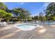 Community pool and hot tub area with tables and chairs available for residents to use and relax outdoors at 12602 Angel Oak Dr, Huntersville, NC 28078