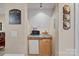 Basement wet bar area complete with mini-fridge, microwave, and decorative Coca-Cola theming at 166 Pinnacle Shores Dr, Mooresville, NC 28117