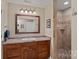 Bathroom with double sink vanity and walk-in shower featuring tile flooring at 166 Pinnacle Shores Dr, Mooresville, NC 28117