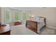 Comfortable bedroom with neutral walls, carpet, natural light, and ample space, creating an inviting personal space at 166 Pinnacle Shores Dr, Mooresville, NC 28117