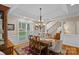 Dining room with a chandelier, large windows, and wood floors at 166 Pinnacle Shores Dr, Mooresville, NC 28117