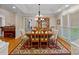 Traditional dining room featuring wood table, chandelier, and large windows for natural light at 166 Pinnacle Shores Dr, Mooresville, NC 28117