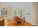Bright dining area with hardwood floors, complemented by a round table with seating for four, nestled beside a window-lined nook at 166 Pinnacle Shores Dr, Mooresville, NC 28117