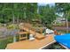Private dock with boat lift offering direct access to the serene lake, surrounded by mature trees at 166 Pinnacle Shores Dr, Mooresville, NC 28117