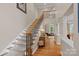 Bright foyer featuring staircase with wooden railing and iron spindles, and hardwood floors at 166 Pinnacle Shores Dr, Mooresville, NC 28117