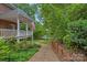 Beautiful home exterior featuring a well-maintained yard, charming brick pathway, and a welcoming covered porch at 166 Pinnacle Shores Dr, Mooresville, NC 28117