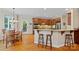 Eat-in kitchen featuring custom cabinets, a granite countertop island, and stainless steel appliances at 166 Pinnacle Shores Dr, Mooresville, NC 28117