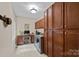 Convenient laundry room with ample storage, a workspace, and modern washer/dryer, offering functionality and organization at 166 Pinnacle Shores Dr, Mooresville, NC 28117