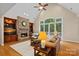 Inviting living room with stone fireplace, built-in shelves, and large windows with backyard views at 166 Pinnacle Shores Dr, Mooresville, NC 28117