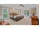 Large main bedroom featuring neutral decor, tray ceiling, and large windows with natural light at 166 Pinnacle Shores Dr, Mooresville, NC 28117
