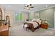 Serene bedroom features neutral tones, plush carpet, and abundant natural light, creating a relaxing and inviting retreat at 166 Pinnacle Shores Dr, Mooresville, NC 28117