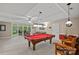 Expansive recreation room with a pool table, bar area, and outdoor access, designed for leisure and entertainment at 166 Pinnacle Shores Dr, Mooresville, NC 28117