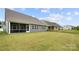 Expansive backyard featuring a lush lawn and multiple covered patios for outdoor living at 17028 River Race Dr, Huntersville, NC 28078
