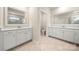 Dual vanities with large mirrors in a bright bathroom with a separate toilet area at 17028 River Race Dr, Huntersville, NC 28078