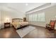 Bright bedroom with tray ceiling, plantation shutters, and hardwood floors at 17028 River Race Dr, Huntersville, NC 28078