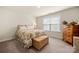 Bright bedroom featuring floral bedding, neutral walls, and a window for natural light at 17028 River Race Dr, Huntersville, NC 28078