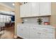 Butler's pantry with white cabinetry, wine rack, and view into dining room at 17028 River Race Dr, Huntersville, NC 28078