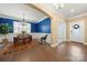Dining room featuring vibrant blue walls, wainscoting, plantation shutters, and hardwood floors at 17028 River Race Dr, Huntersville, NC 28078