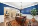 Elegant dining room with blue accent wall, hardwood flooring, and chandelier at 17028 River Race Dr, Huntersville, NC 28078