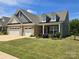 Charming home featuring a two-car garage, well-manicured lawn, and inviting curb appeal at 17028 River Race Dr, Huntersville, NC 28078