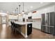 Spacious kitchen island with white countertop, stainless refrigerator, and pendant lighting at 17028 River Race Dr, Huntersville, NC 28078