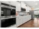 Well-lit kitchen with stainless steel appliances, double oven, and white cabinets at 17028 River Race Dr, Huntersville, NC 28078