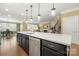 Kitchen island with stainless dishwasher, white countertop, and open floor plan at 17028 River Race Dr, Huntersville, NC 28078