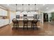 Stylish kitchen island with pendant lights, white cabinets, stainless appliances, and hardwood floors at 17028 River Race Dr, Huntersville, NC 28078