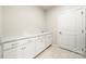 Laundry room with sink, counter space, cabinets, and a tiled floor at 17028 River Race Dr, Huntersville, NC 28078